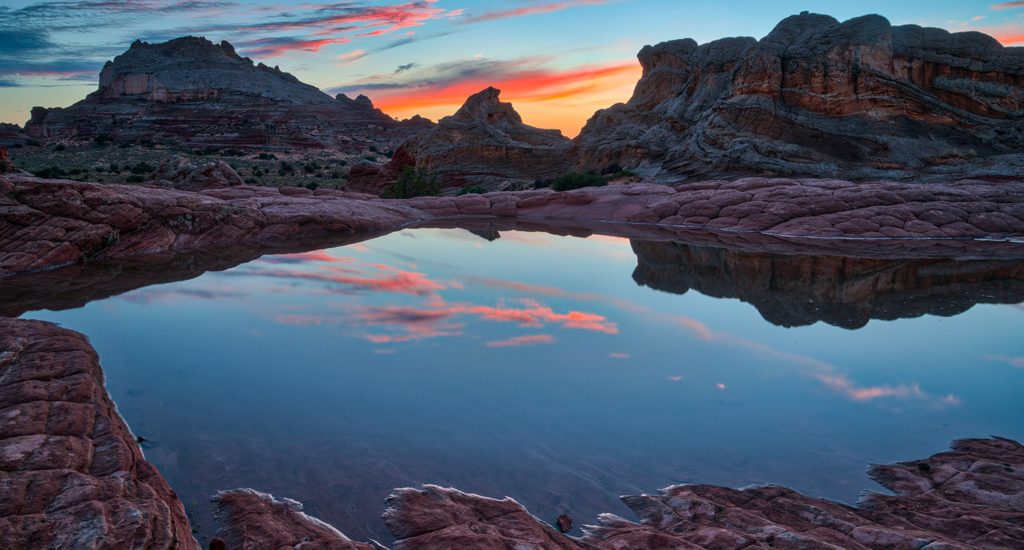 Arizona, Vermilion Cliffs National Monument, White Pocket, rock formations and rainwater pools, sunset