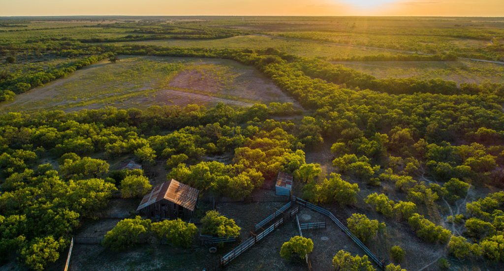 Texas, McCulloch County, aerial view, 2800-acre tract, old barn and pens at sunset